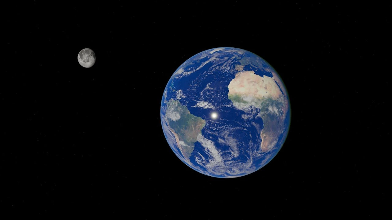 Photograph of Earth and Moon in space against a black background. Earth appears as a large, bright blue sphere with white cloud formations, visible landmasses including Africa and South America, and deep blue oceans. The Moon appears smaller to the left of Earth, showing its grey, cratered surface fully illuminated. Both celestial bodies are shown in high detail with realistic proportions and spacing.