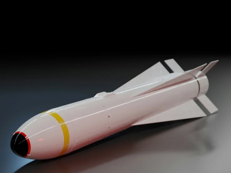 A detailed 3D rendering of a BLU-109 bunker-buster bomb shown in profile view against a dark gradient background. The bomb has a sleek white cylindrical body with stabilizing fins at the rear, a black nose cone, and distinctive yellow and red stripes around its circumference. The bomb's surface appears smooth and reflective, casting subtle shadows on the metallic surface below.